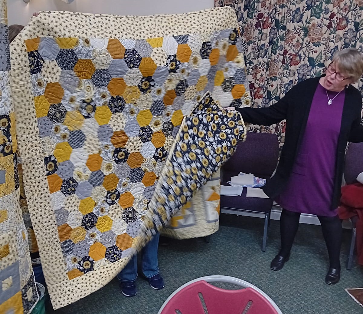 Helen with one of her five coordinating quilts: January 2025 Meeting Show and Tell